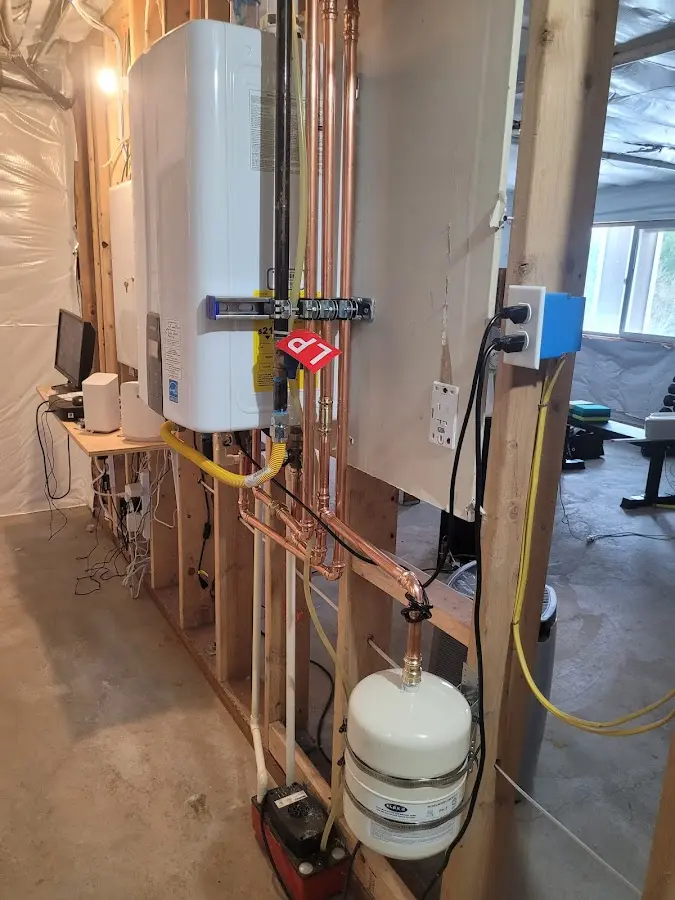Licensed plumber repairing a kitchen sink in Wellesley